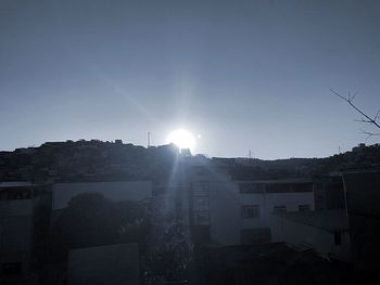 Silhouette buildings against clear sky