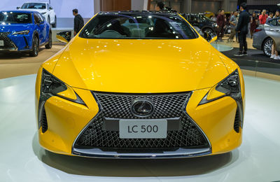 Close-up of yellow car on street