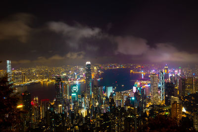 High angle view of illuminated buildings against sky at night