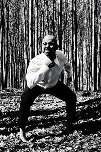 Full length of man standing by tree in forest