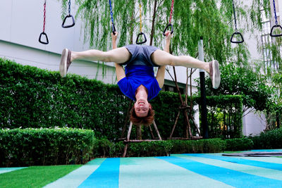 Full length of man hanging on swing