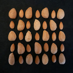 Full frame shot of almonds over black background