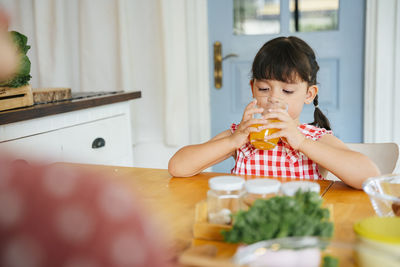 Portrait of boy on table at home