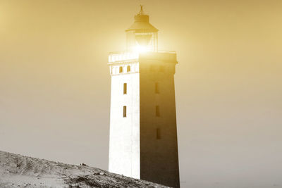 Low angle view of lighthouse against sky at night