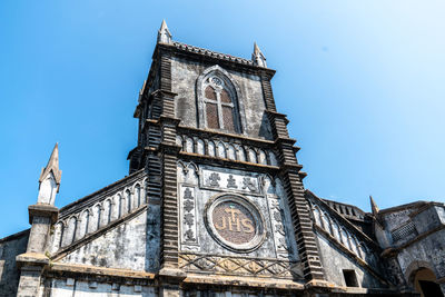 Low angle view of clock tower against sky