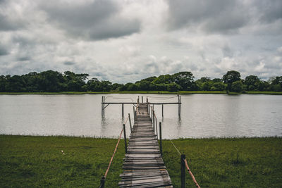 Pier over lake against sky