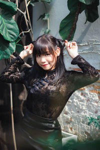 Portrait of a smiling girl holding camera