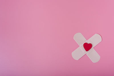 Close-up of heart shape made on pink paper