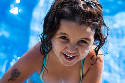 Portrait of happy boy swimming in pool