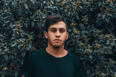 Portrait of man against plants