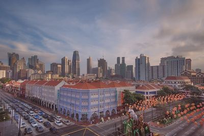 View of cityscape against cloudy sky