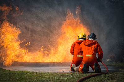 Firefighters spraying water on fire