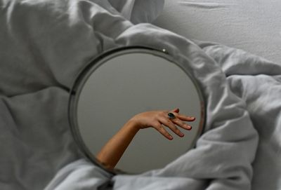 Midsection of woman lying on bed