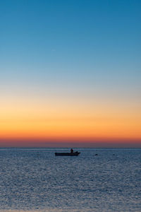 Scenic view of sea against clear sky during sunset