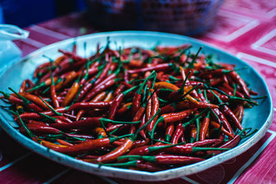 High angle view of red chili peppers in bowl on table