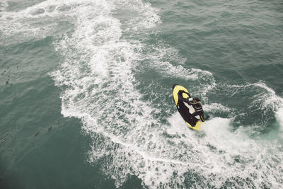 High angle view of people surfing in sea