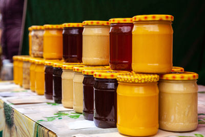 Natural honey in glass jars on the market. jars with various kinds of pure, raw, fresh honey. 