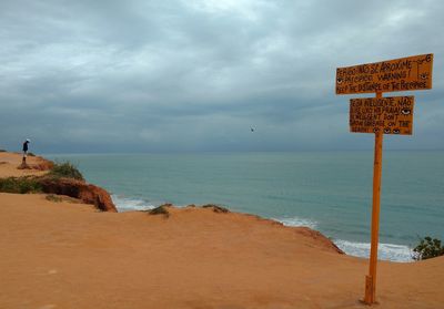 Scenic view of sea against cloudy sky