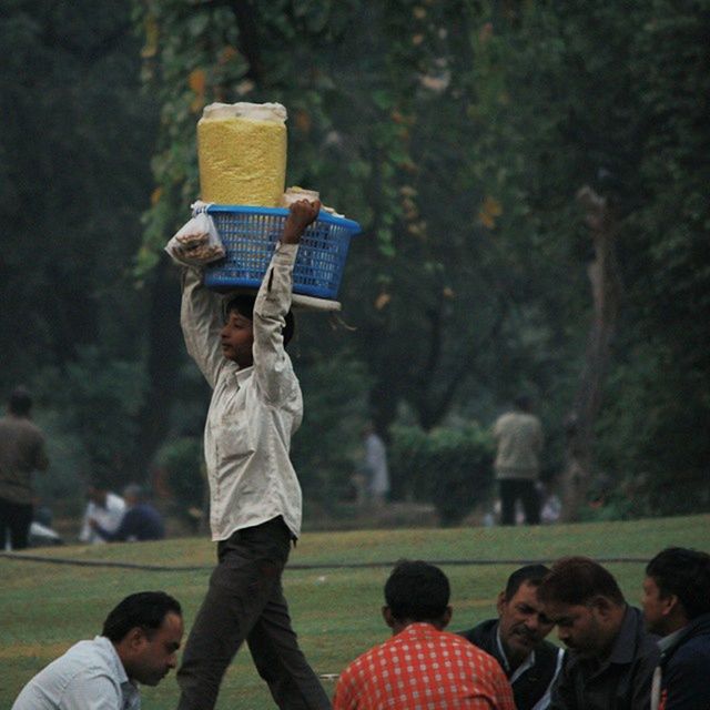 lifestyles, leisure activity, men, togetherness, focus on foreground, photography themes, casual clothing, photographing, holding, playing, tree, boys, bonding, person, love, enjoyment, park - man made space, rear view