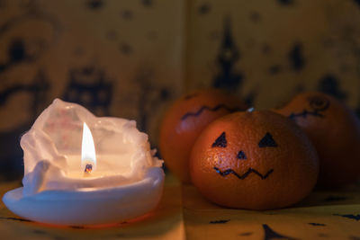 Close-up of illuminated candles on table