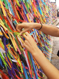 Low section of woman holding multi colored painting