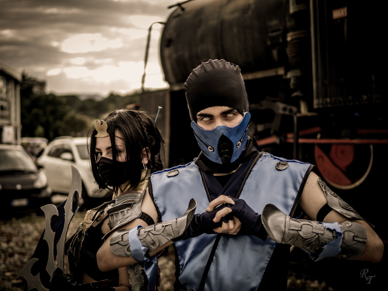 front view, real people, transportation, portrait, mode of transportation, young adult, two people, young men, people, waist up, looking at camera, lifestyles, standing, men, land vehicle, sky, cloud - sky, adult, focus on foreground, occupation, uniform