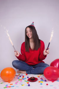 Young woman holding balloons