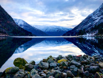 Scenic view of lake and mountains against sky