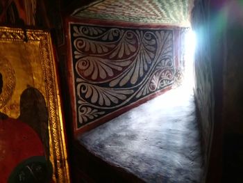 Low angle view of sunlight streaming through door on wall at home