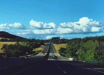 Road passing through bridge against sky