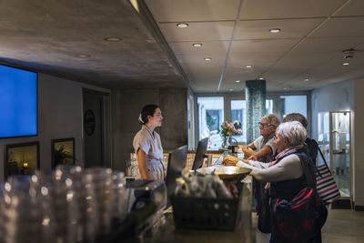 Receptionist assisting customer at health spa