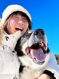 Portrait of young woman with dog