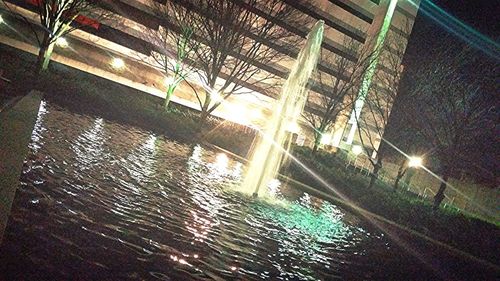 Reflection of illuminated built structure in water