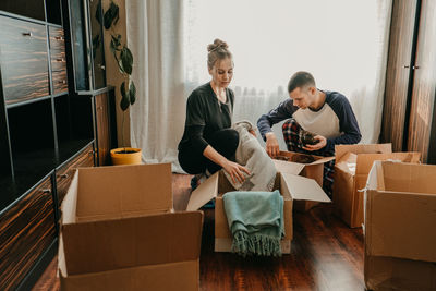 Young couple sitting on floor