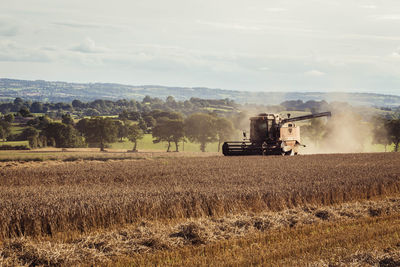 Tractor on field against sky