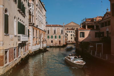 Canal amidst buildings in city