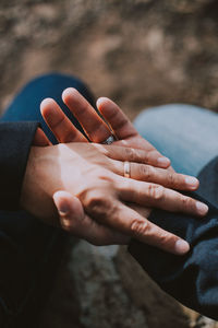 Cropped image of couple holding hands outdoors