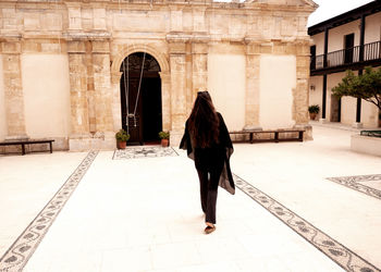 Rear view of woman walking on street