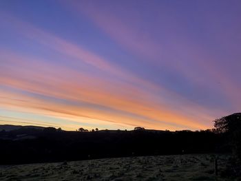 Scenic view of silhouette landscape against romantic sky at sunset