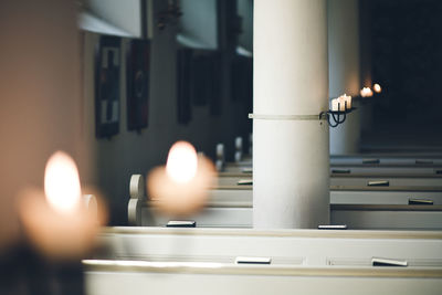 Close-up of lit candles in building