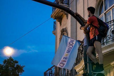 Low angle view of man standing against sky