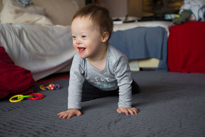 Boy playing on bed at home