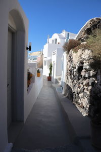 Alley amidst buildings against sky