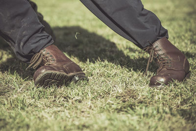 Low section of man on grassy field