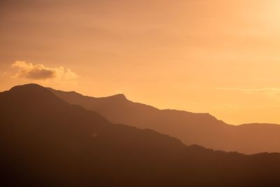 Scenic view of silhouette mountains against sky during sunset