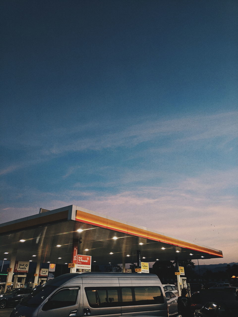 CARS ON ILLUMINATED CITY DURING SUNSET