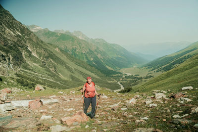 Rear view of man standing on mountain