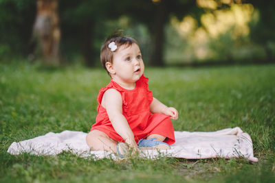 Cute girl sitting on field