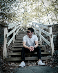 Full length of young man sitting on staircase