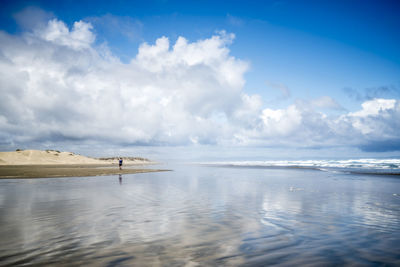 Distant person walking on ninety mile beach